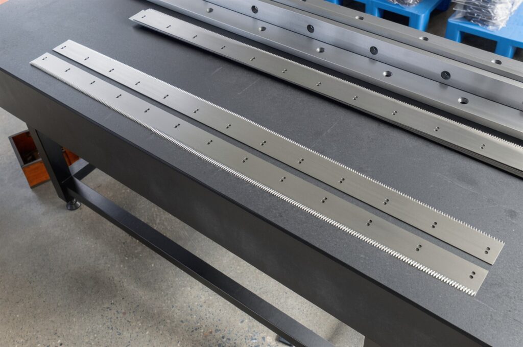 Finished straight blades and shear knives on an inspection table